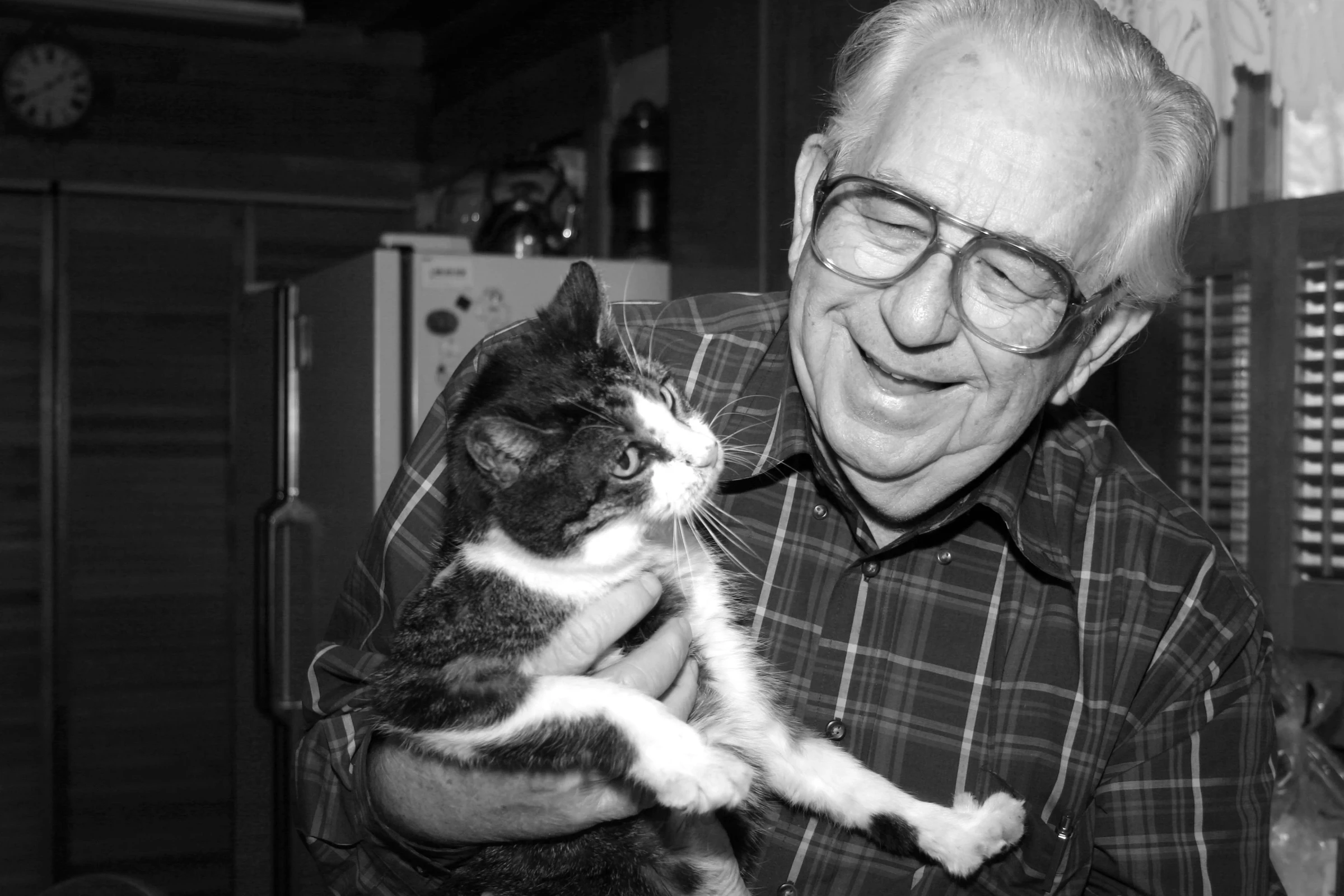 Grandfather comfortably relaxing with his cat